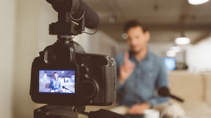 Male vlogger recording content for his video blog.