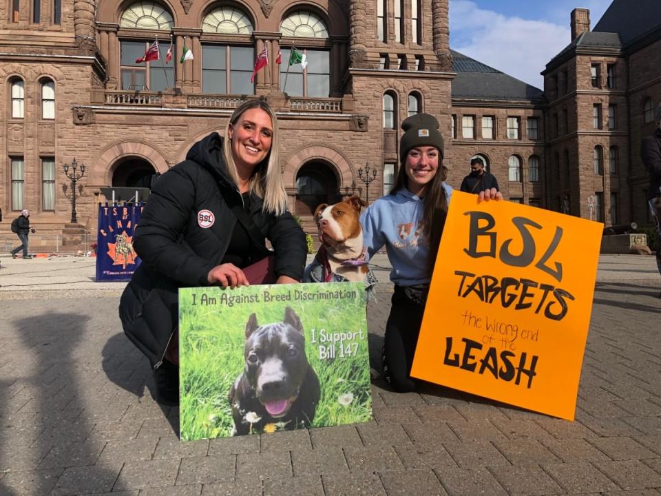 Dozens of people rallied on the grounds of the Ontario legislature on Saturday morning to demand the province remove breed specific language in a provincial ban on pit bulls.  ( Robert Krbavac/CBC - image credit)
