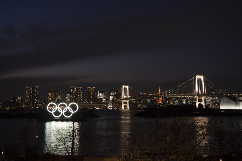 The Olympic rings float in the water near the Rainbow Bridge in the Odaiba section of Tokyo, Monday, March 23, 2020. The Tokyo Olympics are going to happen — but almost surely in 2021 rather than in four months as planned. (AP Photo/Jae C. Hong)