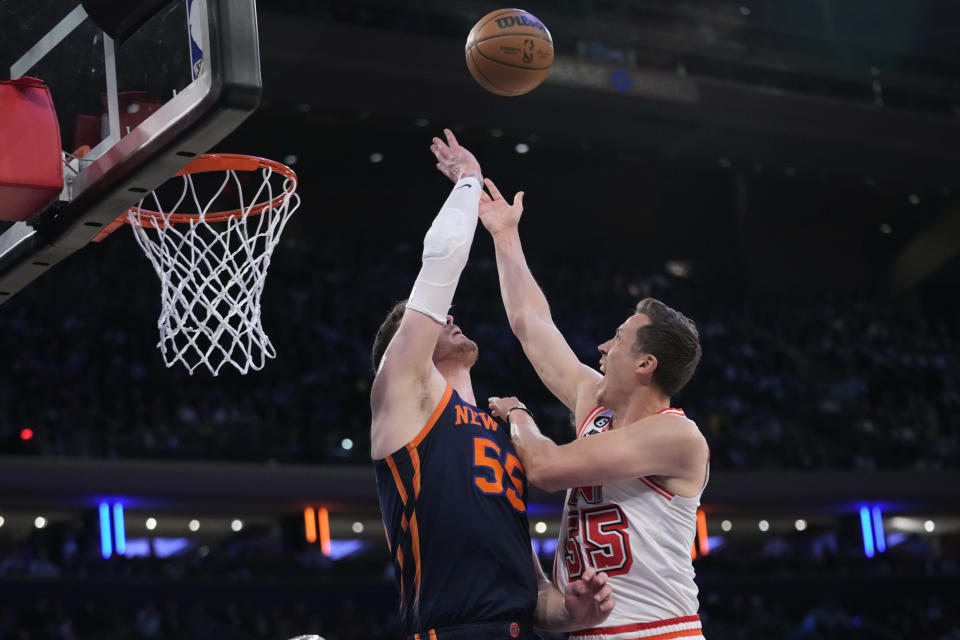 Miami Heat forward Duncan Robinson, right, goes to the basket against New York Knicks center Isaiah Hartenstein in the first half of an NBA basketball game, Wednesday, March 29, 2023, at Madison Square Garden in New York. (AP Photo/Mary Altaffer)