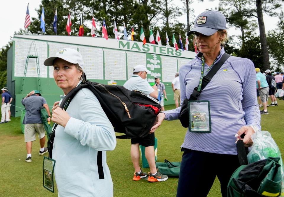 FILE - Apr 7, 2023; Augusta, Georgia, USA; Jodi Streff (right) holds Sylvia Martin's backpack near the Masters scoreboard during the second round of The Masters golf tournament. Mandatory Credit: Rob Schumacher-USA TODAY Network Pga Masters Tournament Second Round