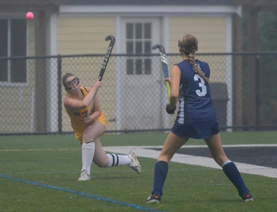 NORTH EASTHAM -- 10/05/22 -- Nauset's Taylor Peirce, left, sends a ball down the field with Monomoy's Sam Clarke looking to block the first period play. Nauset Regional High School hosted Monomoy Regional High School  in field hockey action Wednesday. Merrily Cassidy/Cape Cod Times