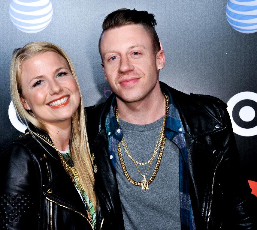 Macklemore, right, and Tricia Davis arrive at Beats Music Launch Party at the Belasco Theatre, Friday, Jan. 24, 2014, in Los Angeles, Calif. (Photo by Richard Shotwell Invision/AP)