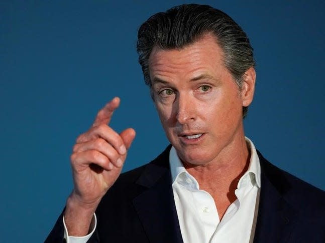 FILE PHOTO - California governor Gavin Newsom speaks at a news conference as he signs SB 113, which will enable the transfer of $331million in state funds to the National Mortgage Special Deposit Fund in San Diego, California, U.S. October 9, 2019.       REUTERS/ Mike Blake