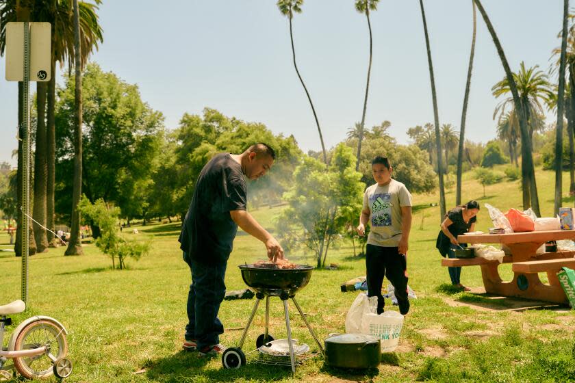 Los Angeles, CA - June 04: A family cooks carne asada at Elysian Park on Sunday, June 04, 2023 in Los Angeles, CA. (Shelby Moore / For The Times)