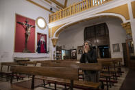 A woman prays at the San Ramon Nonato church after an Easter Holy Week procession was cancelled due to the coronavirus outbreak in Madrid, Spain, Thursday, April 9, 2020. The new coronavirus causes mild or moderate symptoms for most people, but for some, especially older adults and people with existing health problems, it can cause more severe illness or death. (AP Photo/Manu Fernandez)