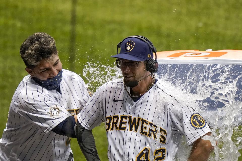 Milwaukee Brewers' Luis Urias dunks Eric Sogard after Sogard hit a walk off two-run home run during the ninth inning of a baseball game against the Pittsburgh Pirates Saturday, Aug. 29, 2020, in Milwaukee. The Brewers won 7-6. (AP Photo/Morry Gash)