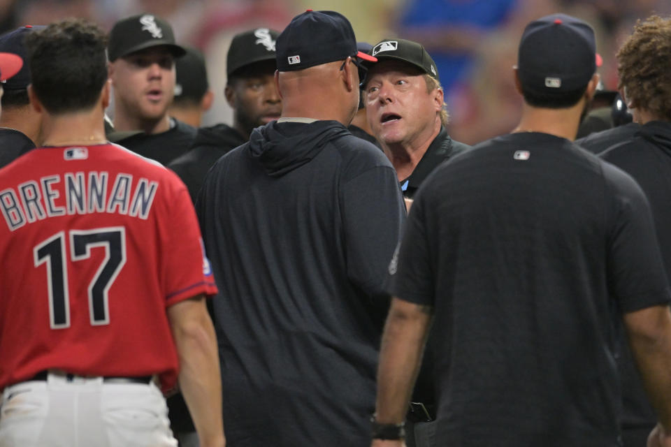 Aug 5, 2023; Cleveland, Ohio, USA; Umpire Bruce Dreckman, center, tries to control the situation after a fight between the Cleveland Guardians and the Chicago White Sox during the sixth inning at Progressive Field. Mandatory Credit: Ken Blaze-USA TODAY Sports