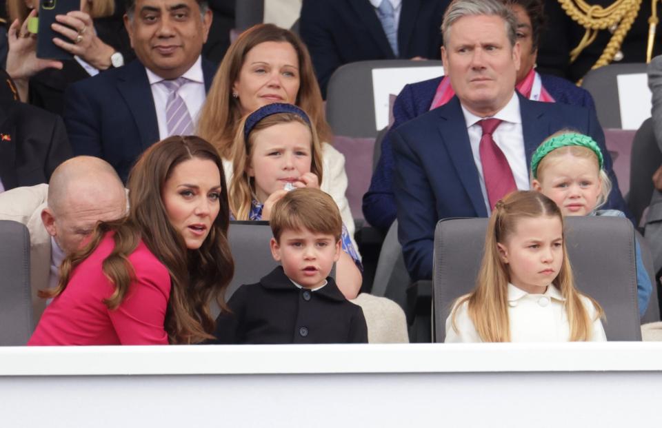 LONDON, ENGLAND - JUNE 05: (L-R 2nd row) Mike Tindall Victoria Starmer, Keir Starmer, (front row) Catherine, Duchess of Cambridge, Prince Louis of Cambridge, and Princess Charlotte of Cambridge watch the Platinum Pageant on June 05, 2022 in London, England. The Platinum Jubilee of Elizabeth II is being celebrated from June 2 to June 5, 2022, in the UK and Commonwealth to mark the 70th anniversary of the accession of Queen Elizabeth II on 6 February 1952. (Photo by Chris Jackson - WPA Pool/Getty Images)