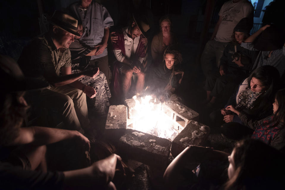 In this Tuesday, March 12, 2019 photo, friends of English tourist Catherine Shaw gather during a memorial for her at a hotel in San Pedro La Laguna, Guatemala. Shaw, whose body was found near a Guatemala highland lake popular with travelers, died of hemorrhaging resulting from a traumatic brain injury, according to an autopsy report completed Tuesday. (AP Photo/Santiago Billy)