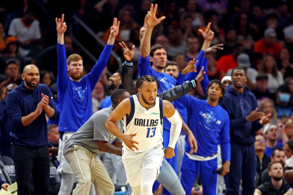 Jalen Brunson (13) and the Mavericks bench reacts after a play against the Suns in Game 7.