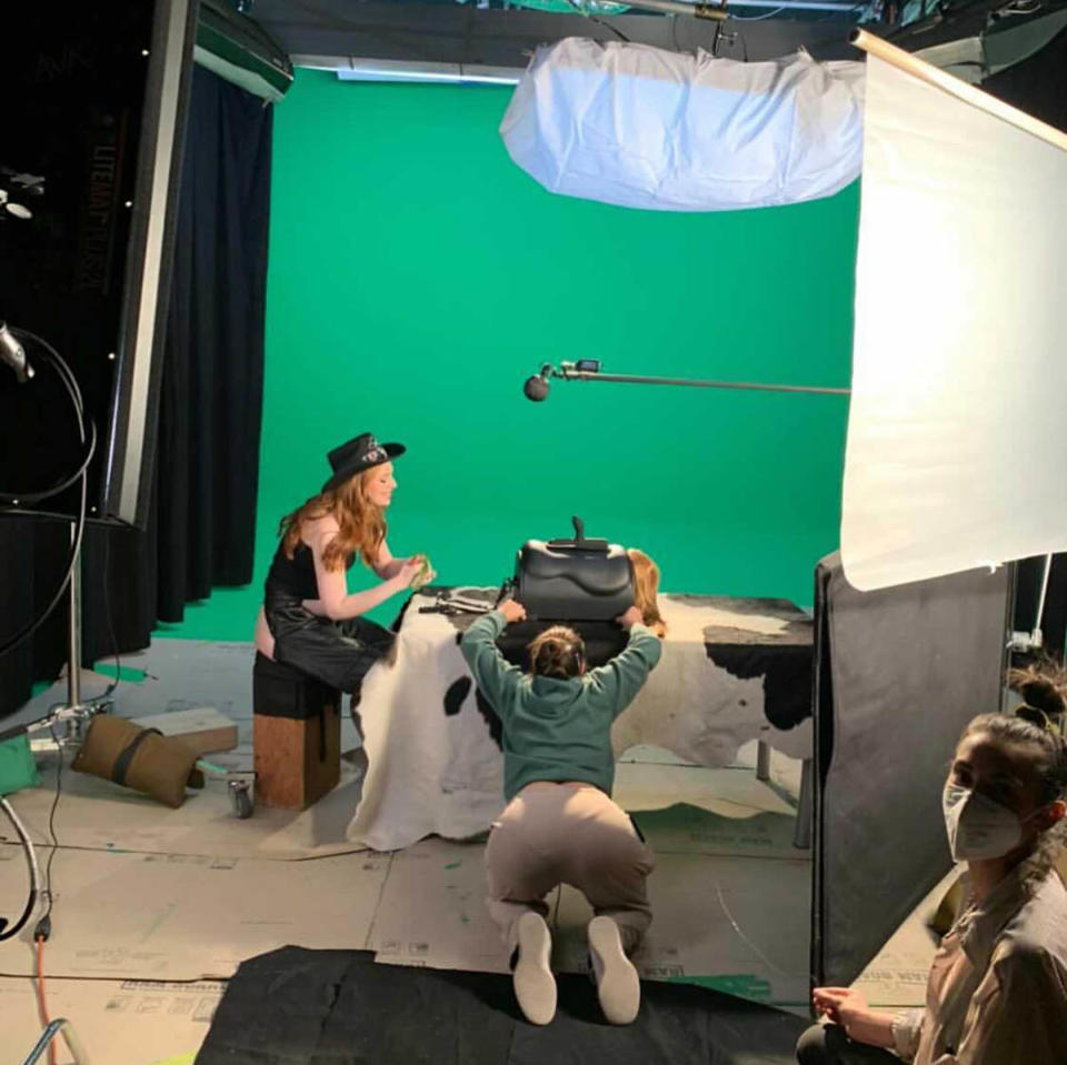 Behind the scenes photo of a film being shot on a green screen