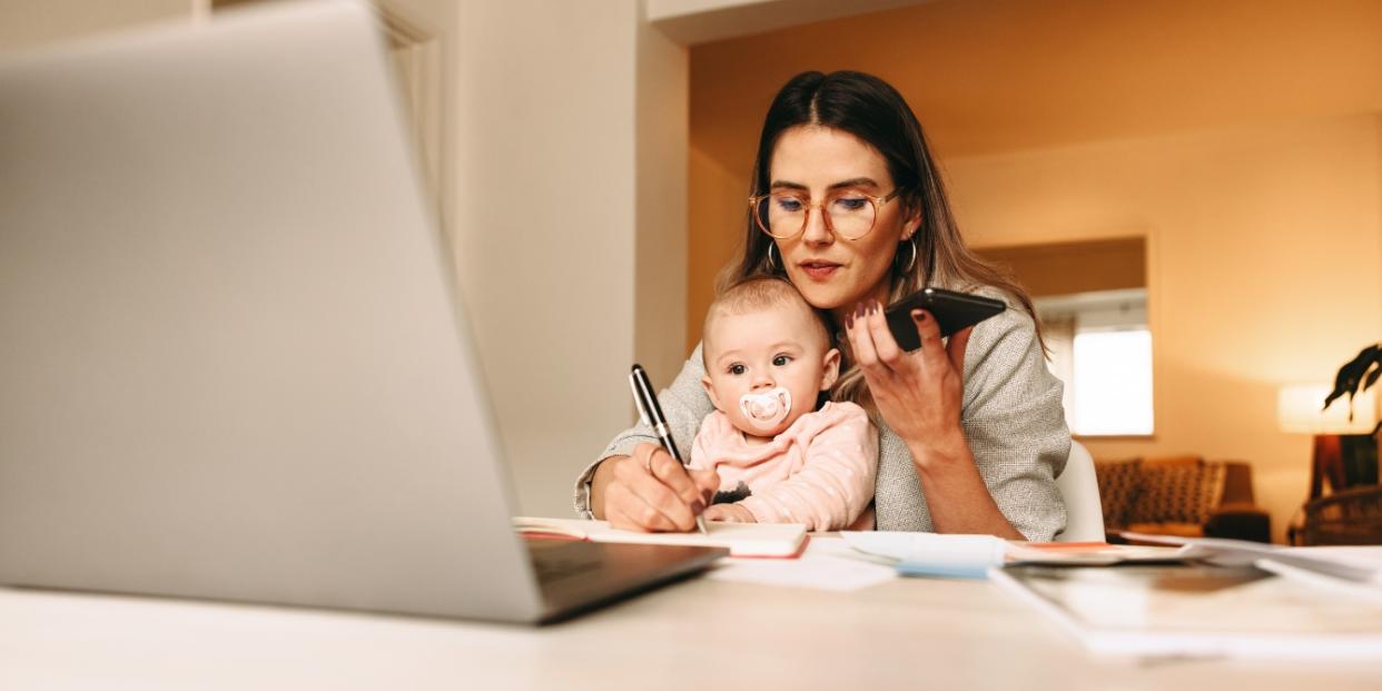 working mom holding baby - balancing a newborn and working