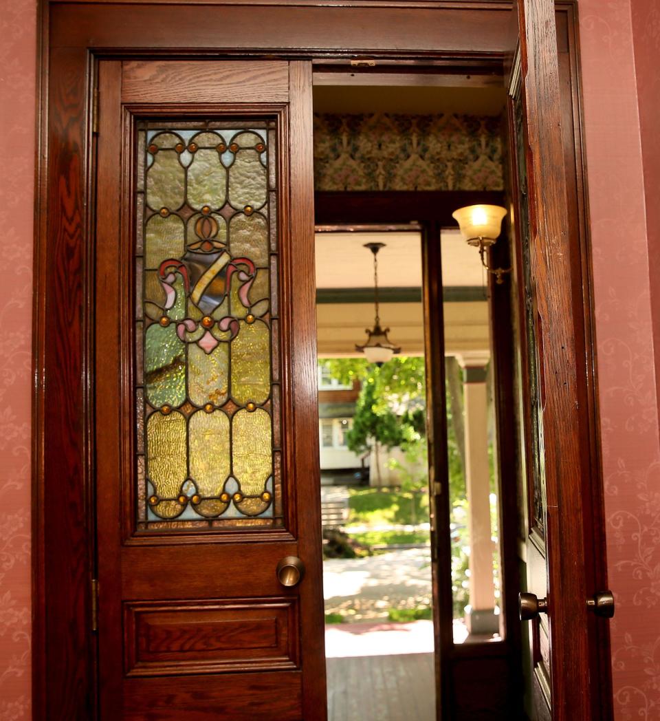 The house, which was student housing and a rental property for a time, retains some of its original features, such as these stained-glass double doors.