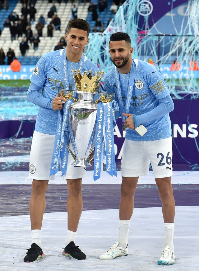Joao Cancelo and Riyad Mahrez celebrate winning the Premier League