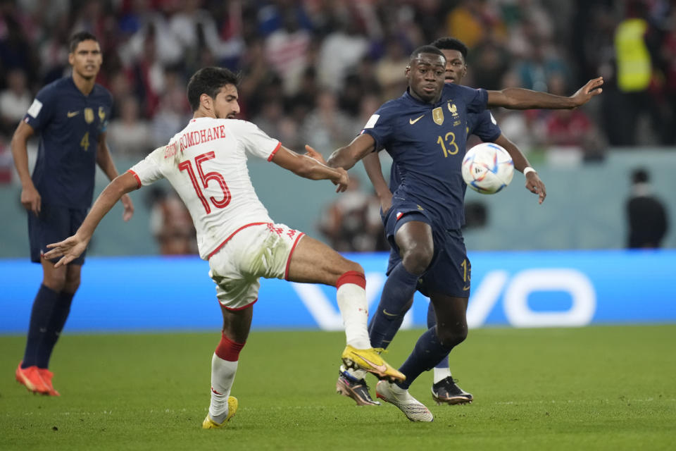 Tunisia's Mohamed Ali Ben Romdhane, left, and France's Youssouf Fofana challenge the ball during the World Cup group D soccer match between Tunisia and France at the Education City Stadium in Al Rayyan , Qatar, Wednesday, Nov. 30, 2022. (AP Photo/Christophe Ena)