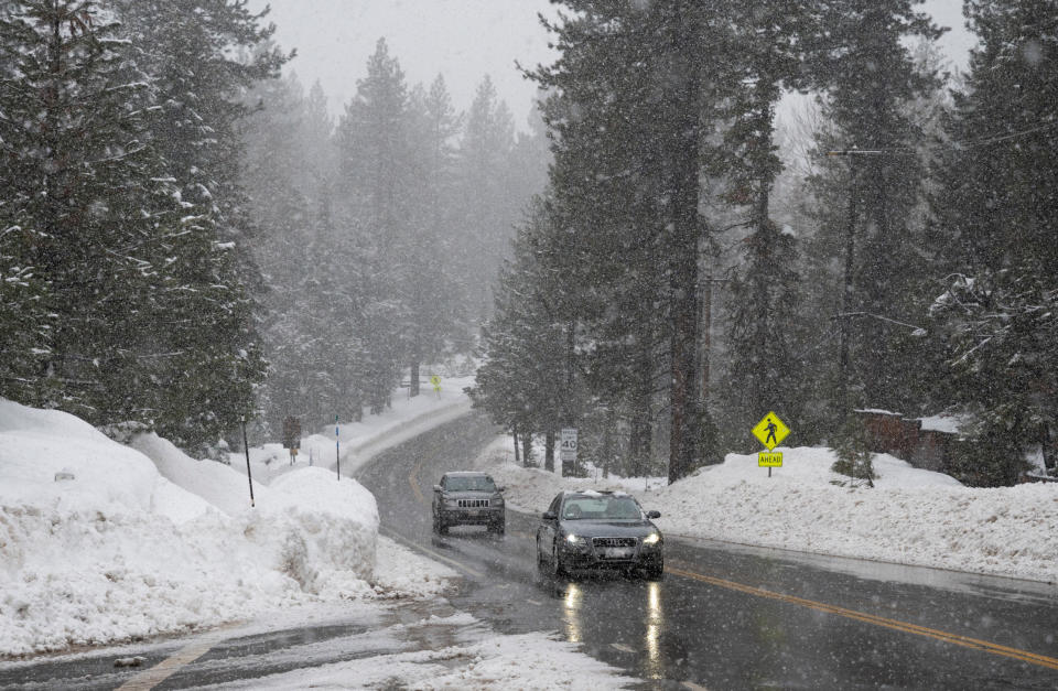 Vehicles move swiftly as snow falls on Highway 89 along the west shore of Lake Tahoe near Tahoma, Calif., on Thursday, Jan. 5, 2023. (Nathaniel Levine/The Sacramento Bee via AP)