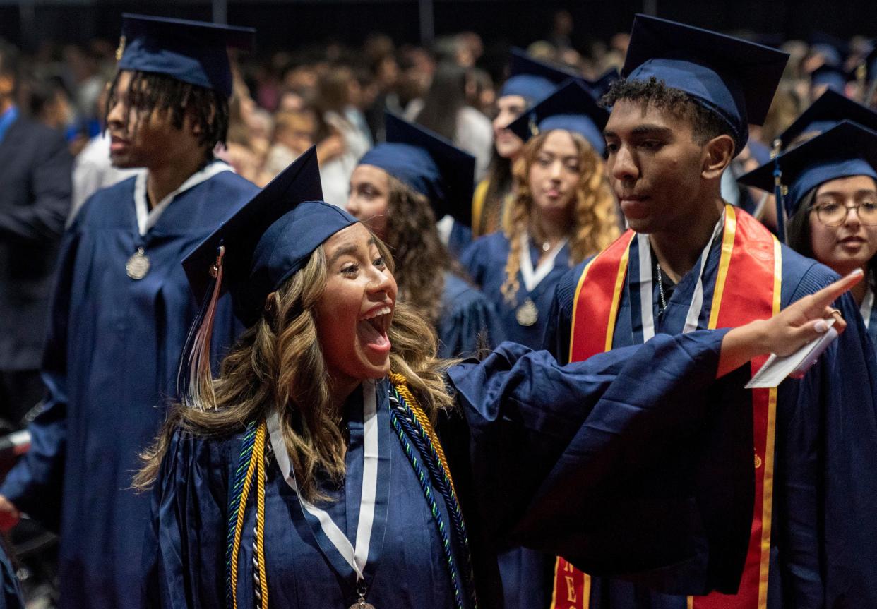 Michelle Tenorio waves to her family during the West Boca High School graduation at the South Florida Fairgrounds on May 16, 2023.