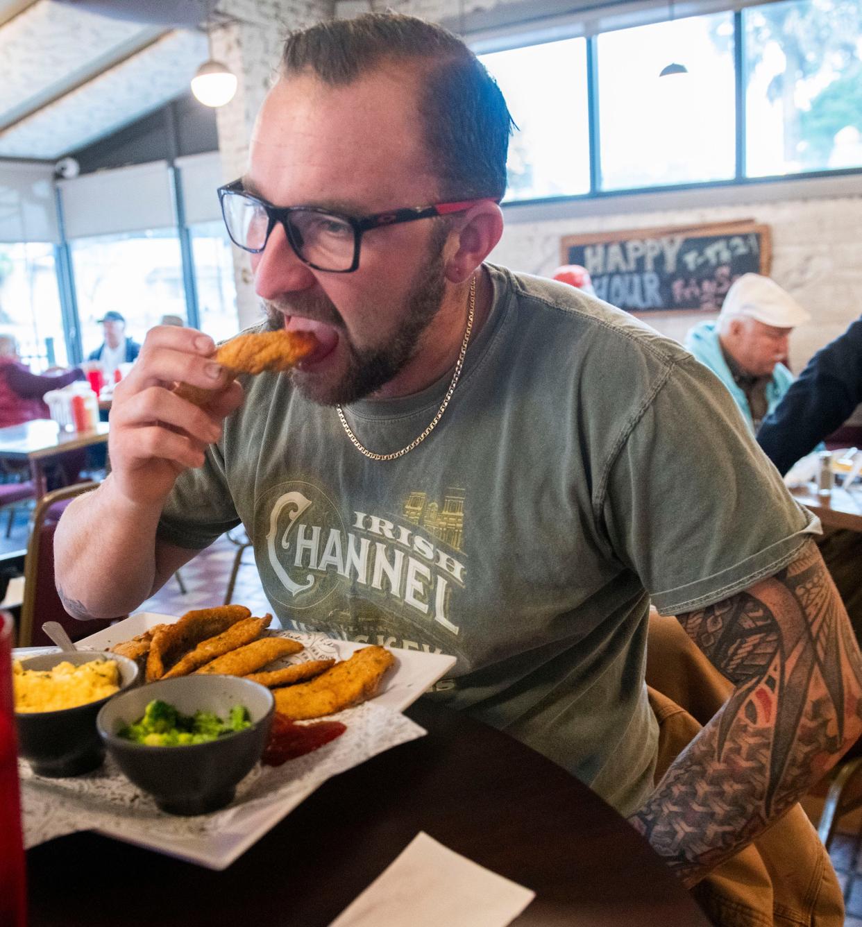 Devin Heindel visits Captain Joey Patti's Seafood on Garden Street in downtown Pensacola for the fried mullet on Wednesday, Jan. 3, 2023.