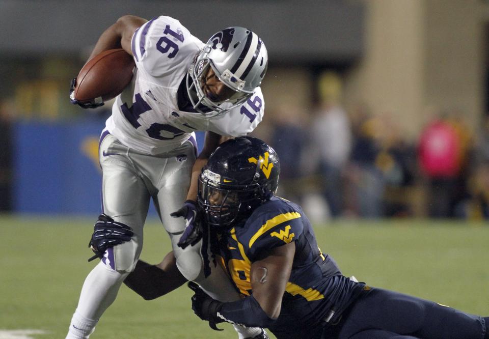 Tyler Lockett #16 of the Kansas State Wildcats runs after the catch against Darwin Cook #25 of the West Virginia Mountaineers during the game on October 20, 2012 at Mountaineer Field in Morgantown, West Virginia. (Photo by Justin K. Aller/Getty Images)