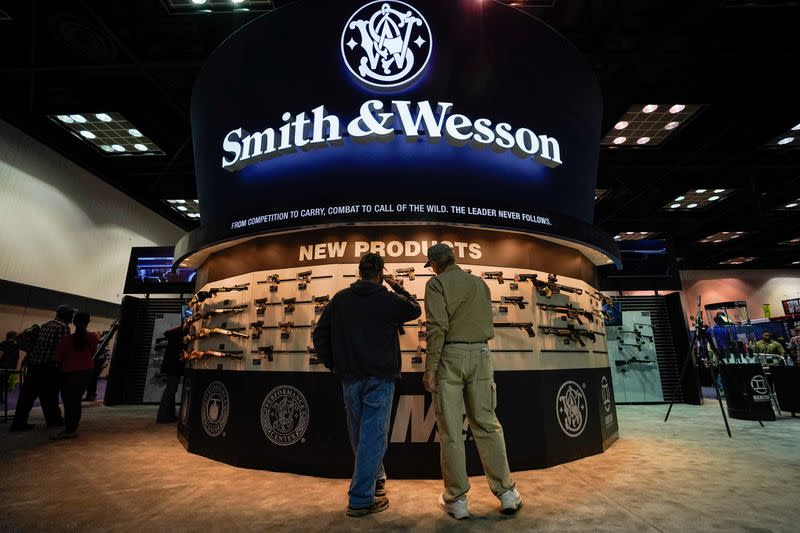 FILE PHOTO: Attendee inspect Smith and Wesson rifles at the National Rifle Association's (NRA) annual meeting, in Indianapolis, Indiana