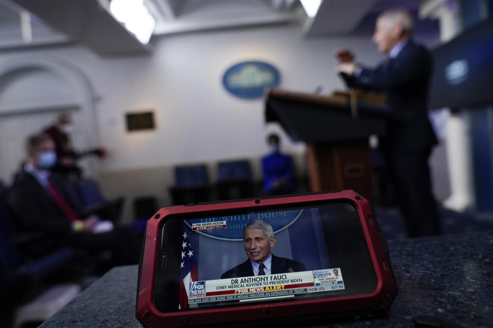 FILE - In this Jan. 21, 2021, file photo A screen displays Dr. Anthony Fauci, director of the National Institute of Allergy and Infectious Diseases, as he speaks with reporters as he speaks in the James Brady Press Briefing Room at the White House in Washington. A new study of people's attitudes toward the press finds that distrust goes deeper than just partisanship and down to how journalists define their mission. Americans want their journalists to be more than watchdogs. (AP Photo/Alex Brandon, File)