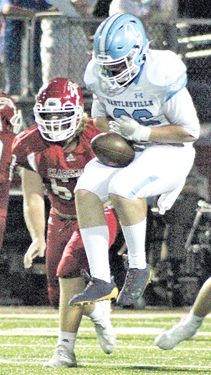 Bartlesville High defensive end Hunter McClintock grabs an interception.