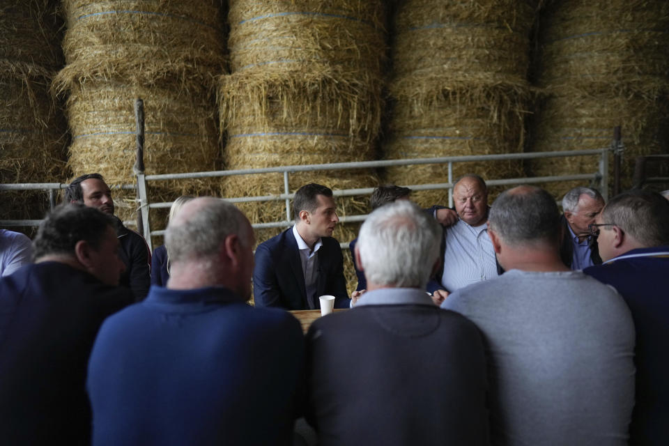 Jordan Bardella far-right National Rally leader for the upcoming election, center, meets farmers as he visits a farm in Chuelles, 137 kms (85 miles) south of Paris, Friday, June 14, 2024. The election is to take place in two rounds on June 30 and July 7. (AP Photo/Thibault Camus)