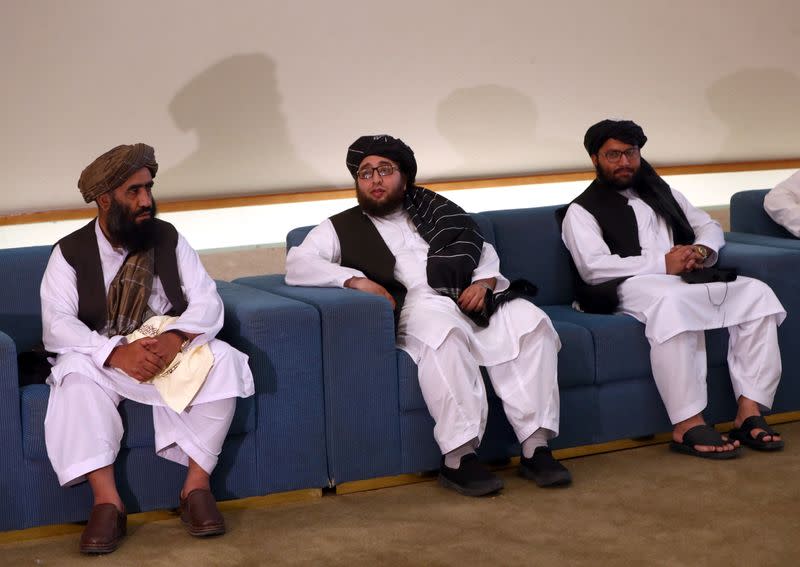 Members of Afghanistan's Taliban delegation sit ahead of an agreement signing between them and U.S. officials in Doha