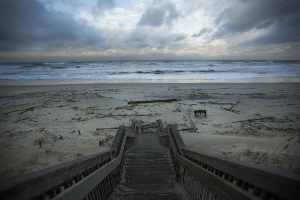 Wood debris is left scattered across the Nags Head beach in the Outer Banks, N.C., as the sunsets, Friday, Sept 6, 2019. Hurricane Dorian continues to churn off the North Carolina coast, but it's heading further into the Atlantic Ocean, prompting forecasters to lift hurricane and tropical storm warnings south of the Virginia-North Carolina border. (L. Todd Spencer/The Virginian-Pilot via AP)