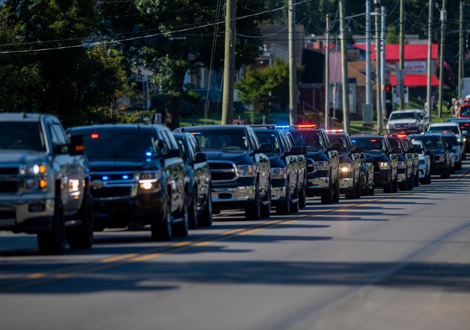 Law enforcement vehicles line 12th Street in preparation for a funeral procession to honor fallen Tell City Police Sgt. Heather Glenn in Tell City, Ind., Monday morning, July 10, 2023. Glenn died in the line of duty during a shooting at Perry County Memorial Hospital.