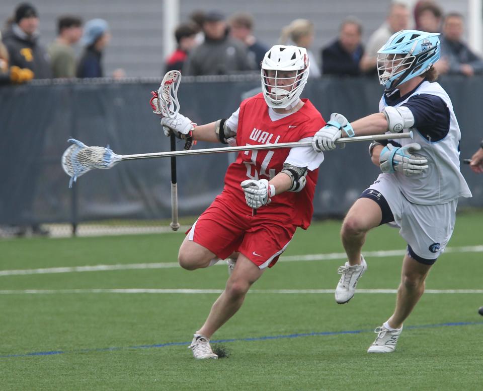 Wall's William Madden (#24) moves down the field with CBA's Jackson Gervais (#13) at his side during their game in Middletown Wednesday, April 10, 2024.