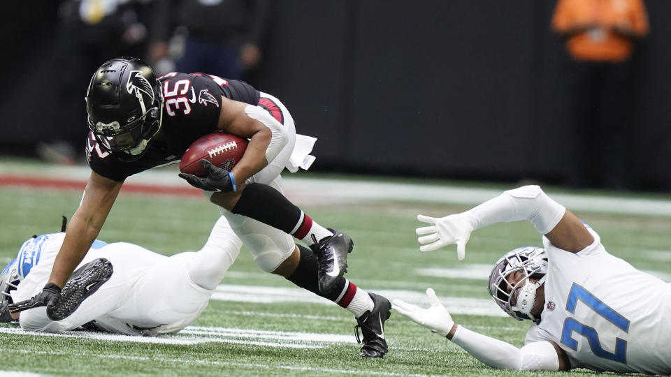 Detroit Lions cornerback Bobby Price (27) trips up Atlanta Falcons cornerback Avery Williams (35) during the first half of an NFL football game, Sunday, Dec. 26, 2021, in Atlanta. (AP Photo/Brynn Anderson)