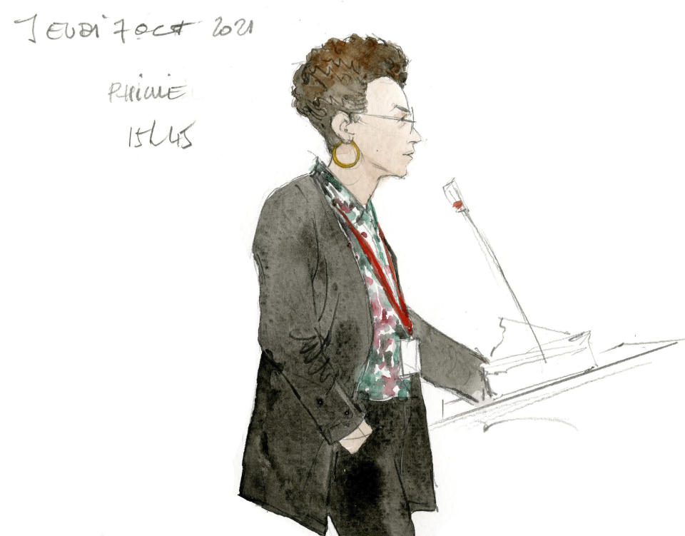 A woman named Pricille testifies Thursday Oct.7, 2021 during the Paris Attacks trial in Paris. For more than two weeks, dozens of survivors from the Bataclan concert hall in Paris have testified in a specially designed courtroom about the Islamic State’s attacks on Nov. 13, 2015 – the deadliest in modern France. The testimony marks the first time many survivors are describing – and learning – what exactly happened that night at the Bataclan, filling in the pieces of a puzzle that is taking shape as they speak. (Noelle Herrenschmidt via AP)
