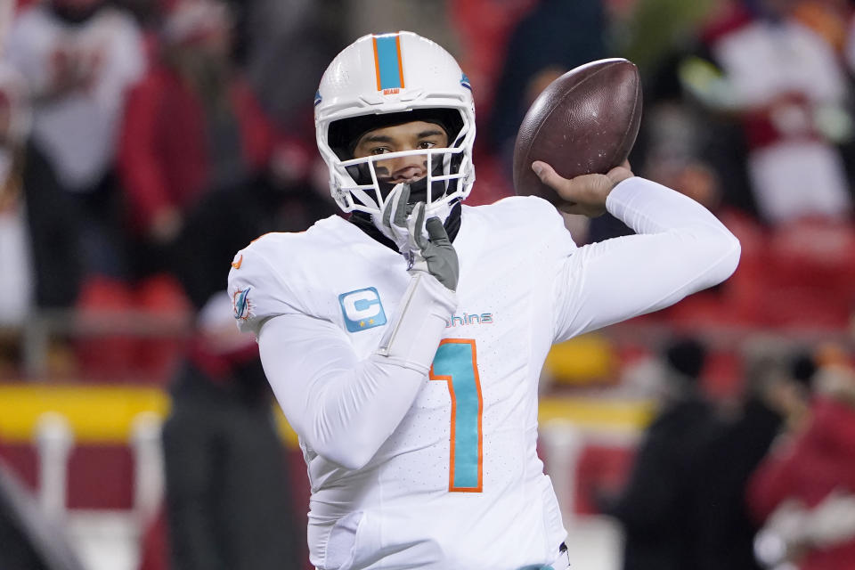 Miami Dolphins quarterback Tua Tagovailoa (1) warms up before an NFL wild-card playoff football game against the Kansas City Chiefs Saturday, Jan. 13, 2024, in Kansas City, Mo. (AP Photo/Ed Zurga)