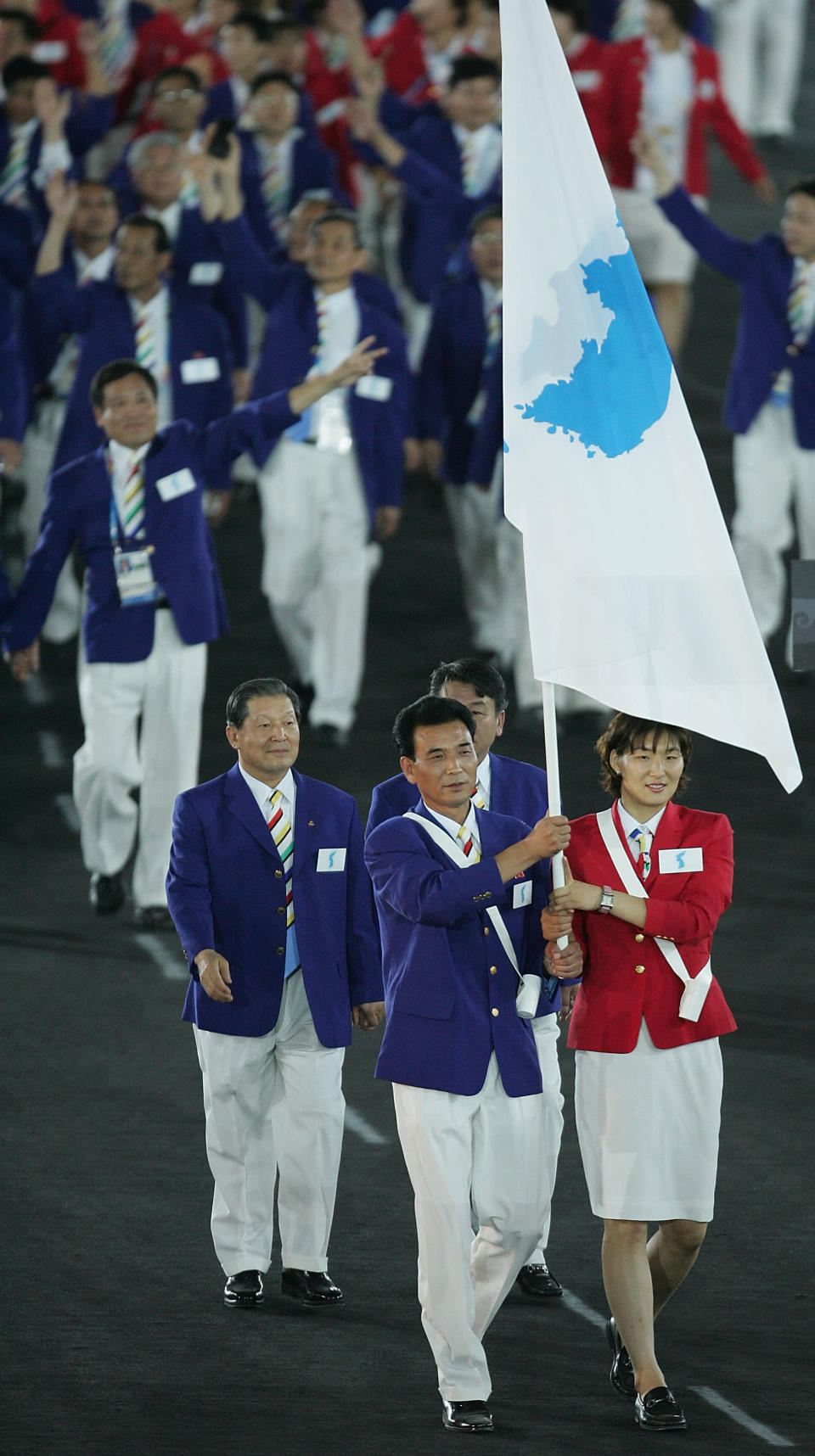 North and South Korean teams marched together under The Unification Flag in the opening ceremonies of the 2000 Summer Olympics in Sydney and the 2004 Summer Olympics in Athens. The flag represents North and South Korea. The background is white and i the centre there is a blue silhouette of the Korean peninsula. The flag has no status as the official flag of either country.