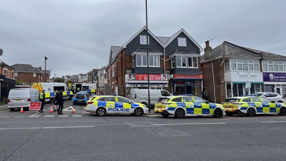 police cars line the street at the entrance to Markham Road