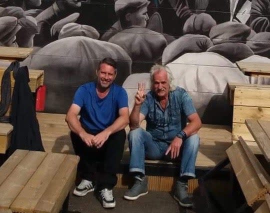 <p>Mark Ervine, street artist and son of the late Progressive Unionist Party (PUP) leader David Ervine, stands near a mural he worked on on the peace line in West Belfast</p> ( )