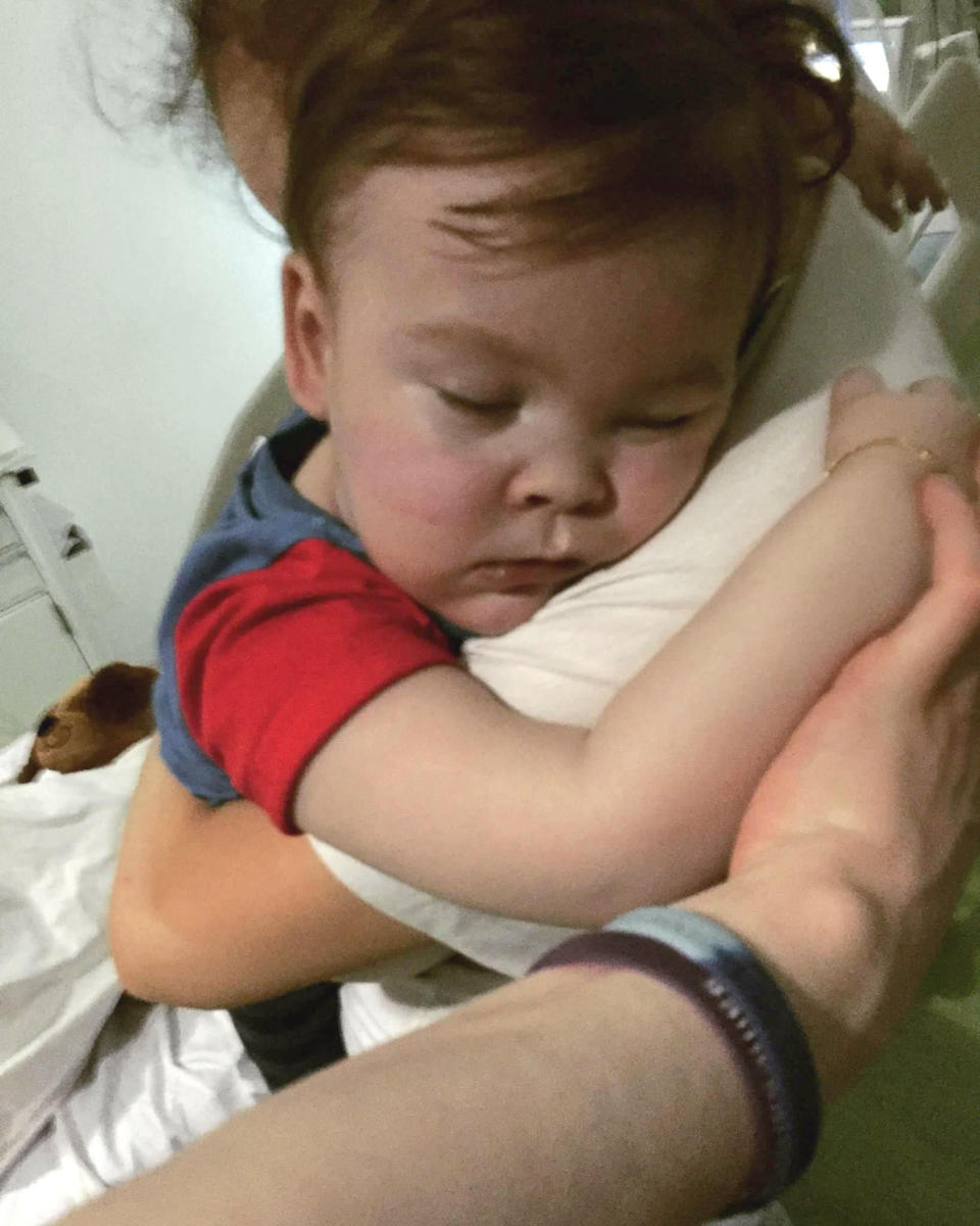 Alfie is cuddled by his mother, Kate James (Picture: PA)