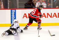 NEWARK, NJ - JUNE 02: Travis Zajac #19 of the New Jersey Devils handles the puck as Drew Doughty #8 of the Los Angeles Kings looks on without his stick during Game Two of the 2012 NHL Stanley Cup Final at the Prudential Center on June 2, 2012 in Newark, New Jersey. (Photo by Paul Bereswill/Getty Images)