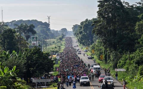 Honduran migrants take part in a caravan heading to the US on the road linking Ciudad Hidalgo and Tapachula, Chiapas state, Mexico  - Credit: AFP