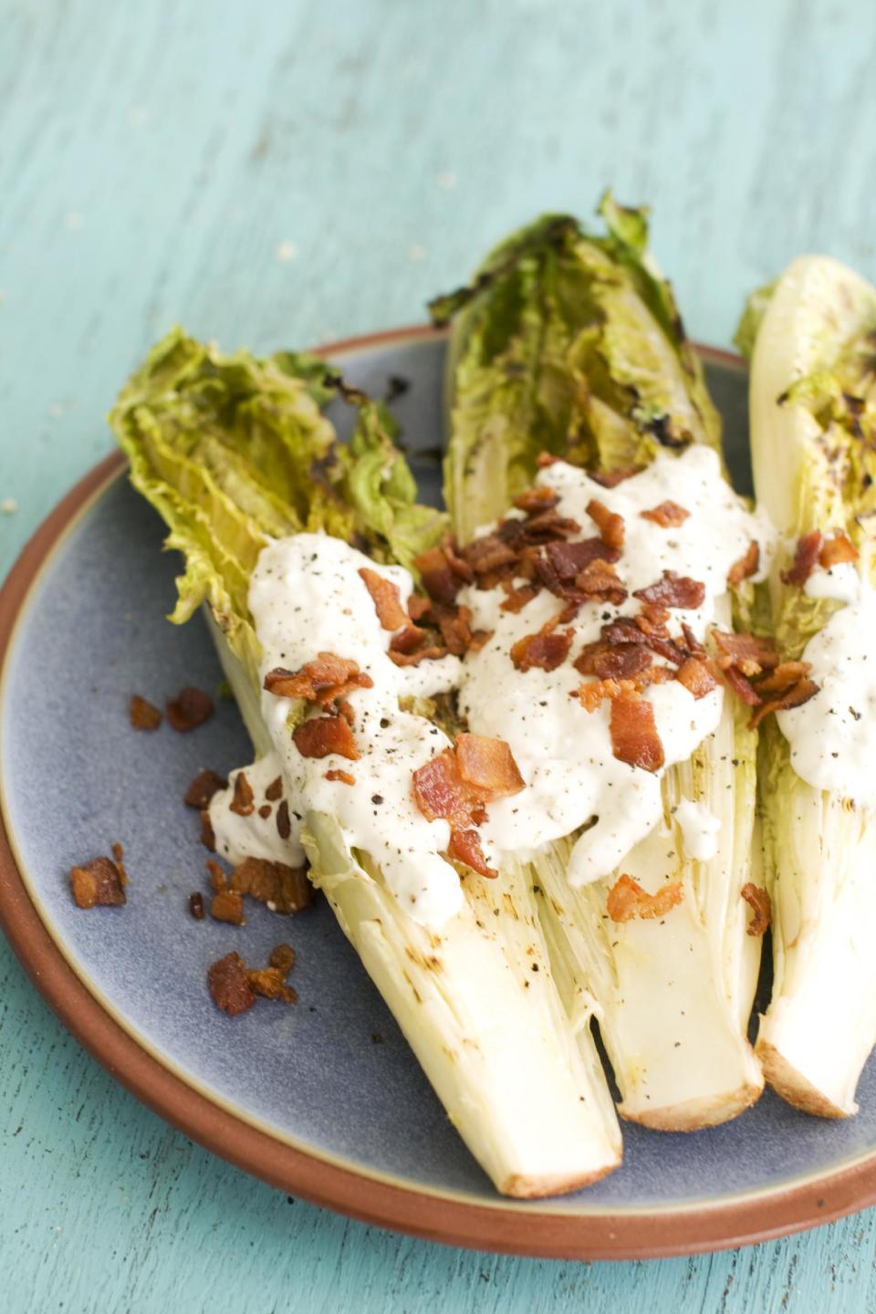 In this image taken on May 13, 2013, grilled hearts of romaine with blue cheese dressing are shown served on a plate in Concord, N.H. (AP Photo/Matthew Mead)