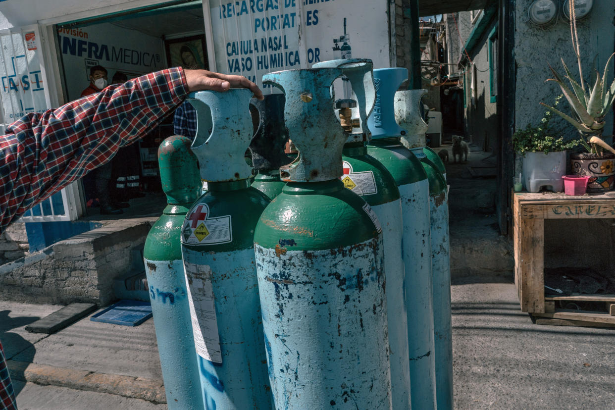 Empty oxygen tanks outside an uncertified private oxygen provider in Mexico City on Wednesday, Feb. 3, 2021. With hospitals overrun, Mexicans fighting the coronavirus at home face a deadly hurdle: a lack of oxygen tanks. (Luis Antonio Rojas/The New York Times)