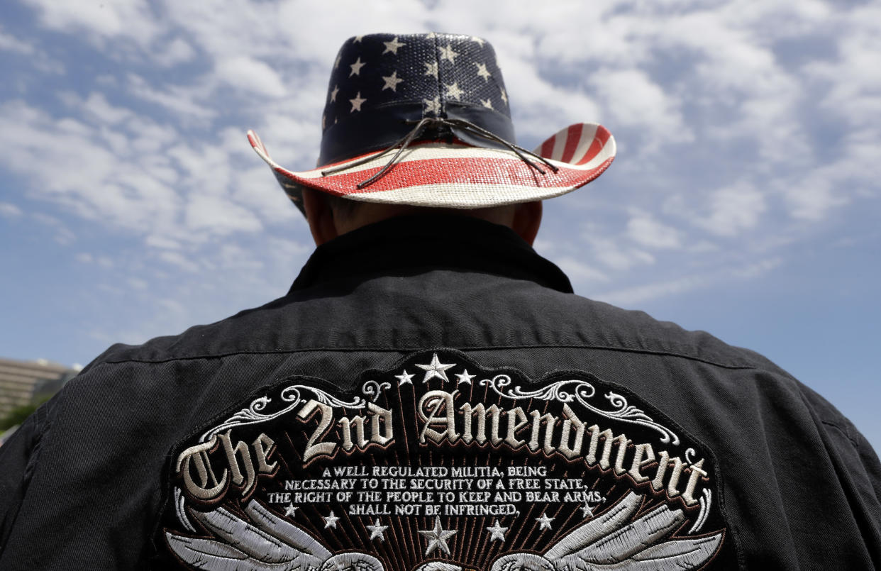 FILE - A man wears a patriotic-themed cowboy hat during a pro gun-rights rally at the Texas Capitol, April 14, 2018, in Austin, Texas. Guns have long been a part of Texas culture — both in the state’s mythology and in reality. But to equate the number of guns with the number of people killed by guns strikes some as a false equivalence. (AP Photo/Eric Gay, File)