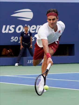 Sept 1, 2018; New York, NY, USA; Roger Federer of Switzerland hits a return of a drop shot from to Nick Kyrgios of Australia around the net in a third round match on day six of the 2018 U.S. Open tennis tournament at USTA Billie Jean King National Tennis Center. Mandatory Credit: Robert Deutsch-USA TODAY Sports