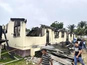 In this photo provided by Guyana's Department of Public Information, the dormitory of a secondary school is burned in Mahdia, Guyana, Monday, May 22, 2023. A nighttime fire raced through the dormitory early Monday, killing at least 19 students and injuring several others, authorities said. (Guyana's Department of Public Information via AP Photo)