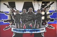 FILE - A mural depicting mercenaries of Russia's Wagner Group that reads: "Wagner Group - Russian knights" vandalized with paint on a wall in Belgrade, Serbia, on Jan. 13, 2023. Russia's Wagner Group, a private military company led by Yevgeny Prigozhin, a rogue millionaire with longtime links to Russia's President Vladimir Putin, has played an increasingly visible role in the fighting in Ukraine. (AP Photo/Darko Vojinovic, File)