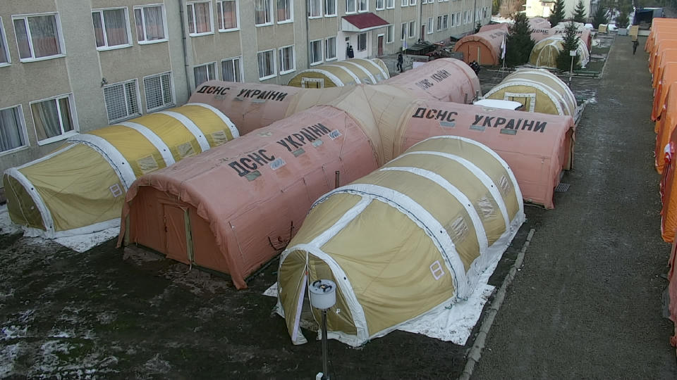 In this photo released by Ukraine's Emergency Situation Ministry on Feb. 20, 2021, a mobile hospital is set up in front of a regional hospital in the Ivano-Frankivsk region, Ukraine. After several delays, Ukraine finally on Tuesday, Feb. 23, 2021, received 500,000 doses of the AstraZeneca vaccine marketed under the name CoviShield, the first shipment of Covid-19 vaccine doses. The country of 40 million is one of the last in the region to begin inoculating its population. (Emergency Situation Ministry via AP)