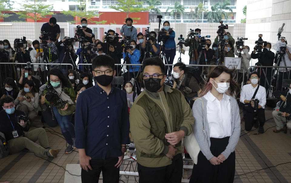 Hong Kong activists, from left, Joshua Wong, Ivan Lam and Agnes Chow arrive at a court in Hong Kong, Monday, Nov. 22. 2020. The trio appears at court for their trial as they face charges related to the besieging of a police station during anti-government protests last year. (AP Photo/Vincent Yu)