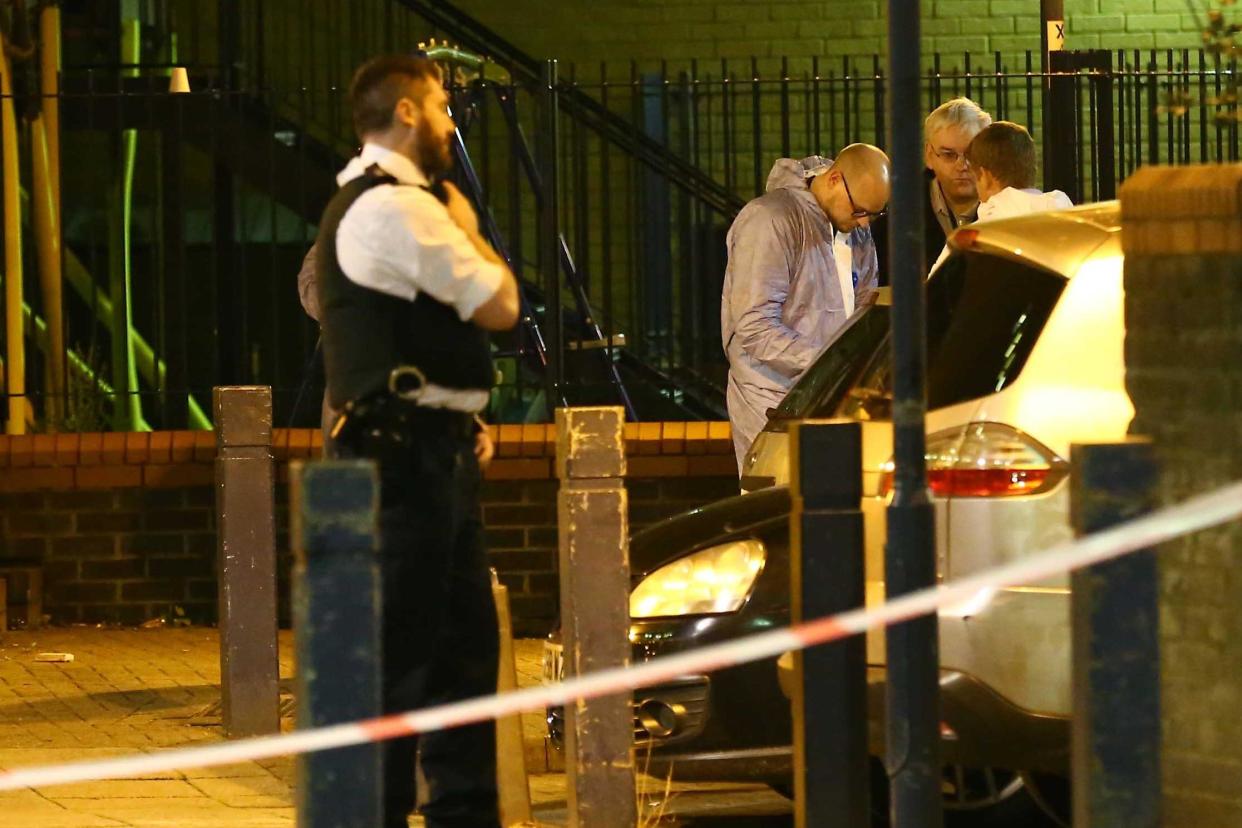 Police and forensic staff at the scene in Battersea after a man was found dead: Nigel Howard